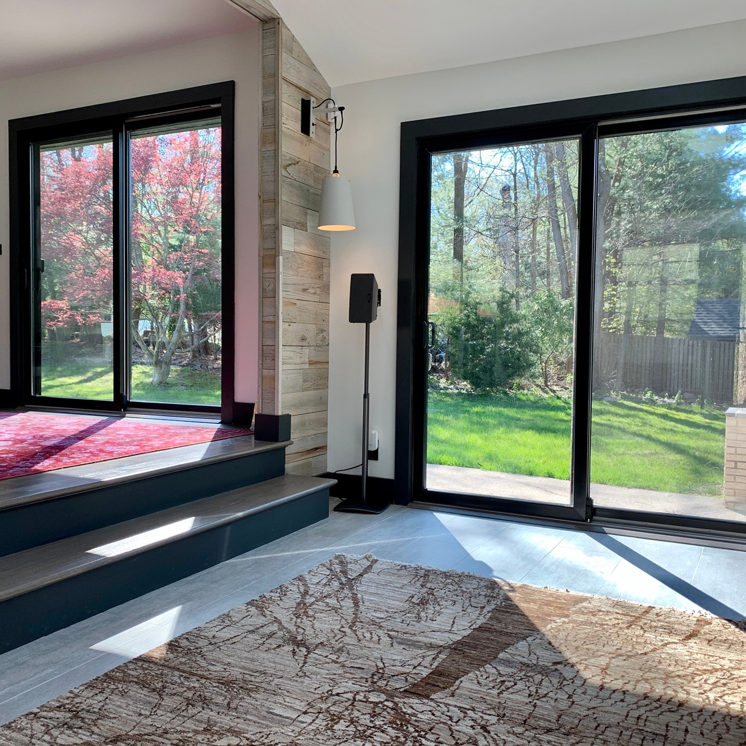 View of the backyard from inside the living room looking out the sliding patio doors.