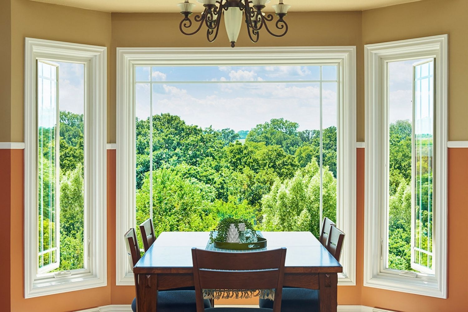 Bay window configuration with a picture window in the middle and casement windows on either side in the eating area of a kitchen.