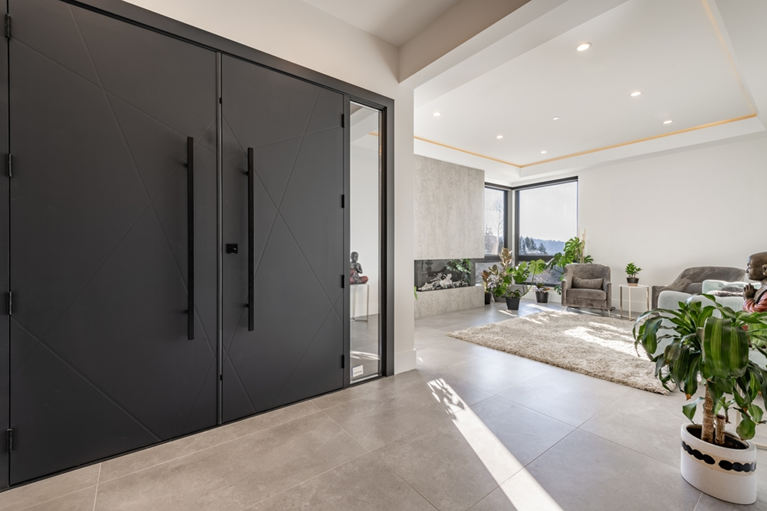 A view of black double entry doors from the interior of a modern home. 