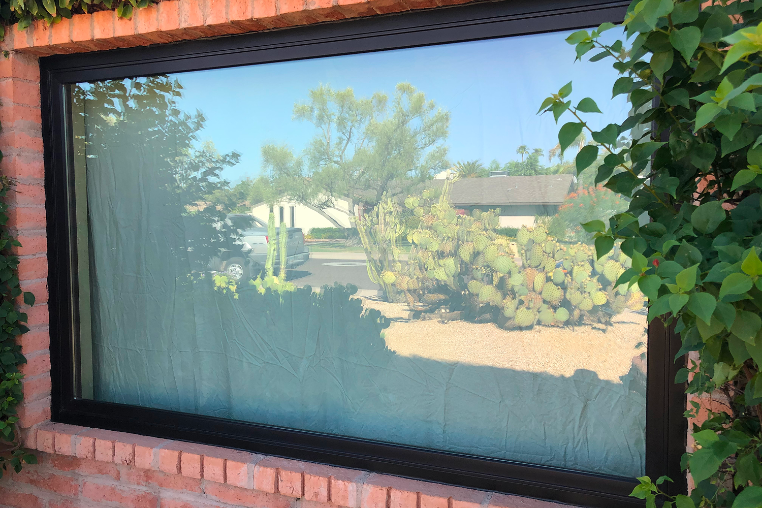 View of a picture window in a basement from the home's exterior.