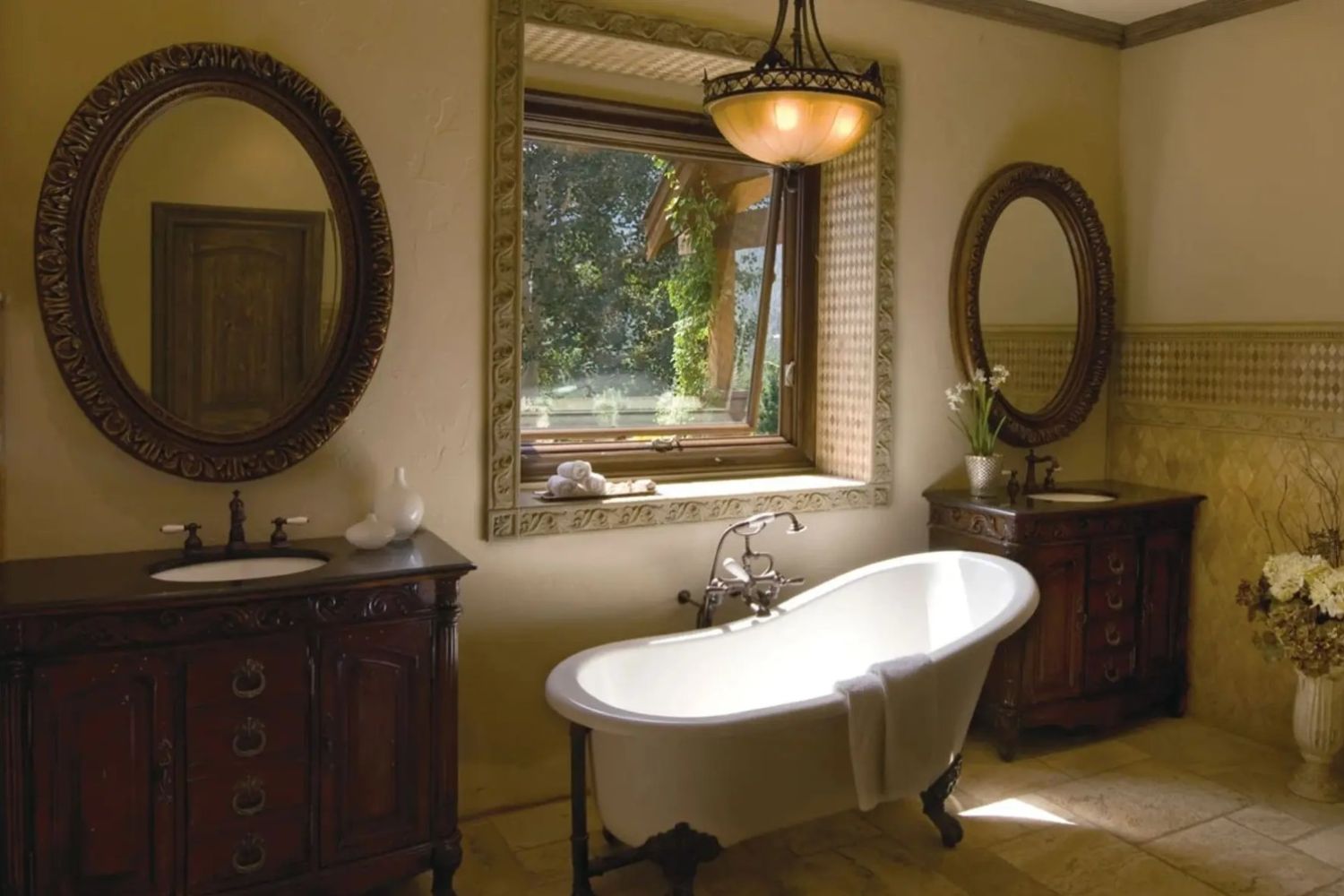Rustic bathroom with a claw-foot bathtub situated in front of an awning window