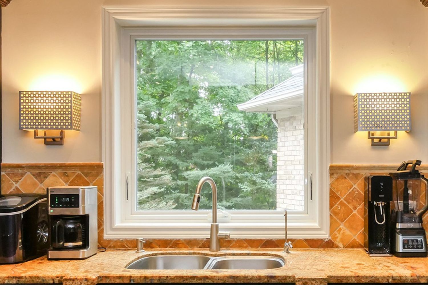Square awning window behind the kitchen sink