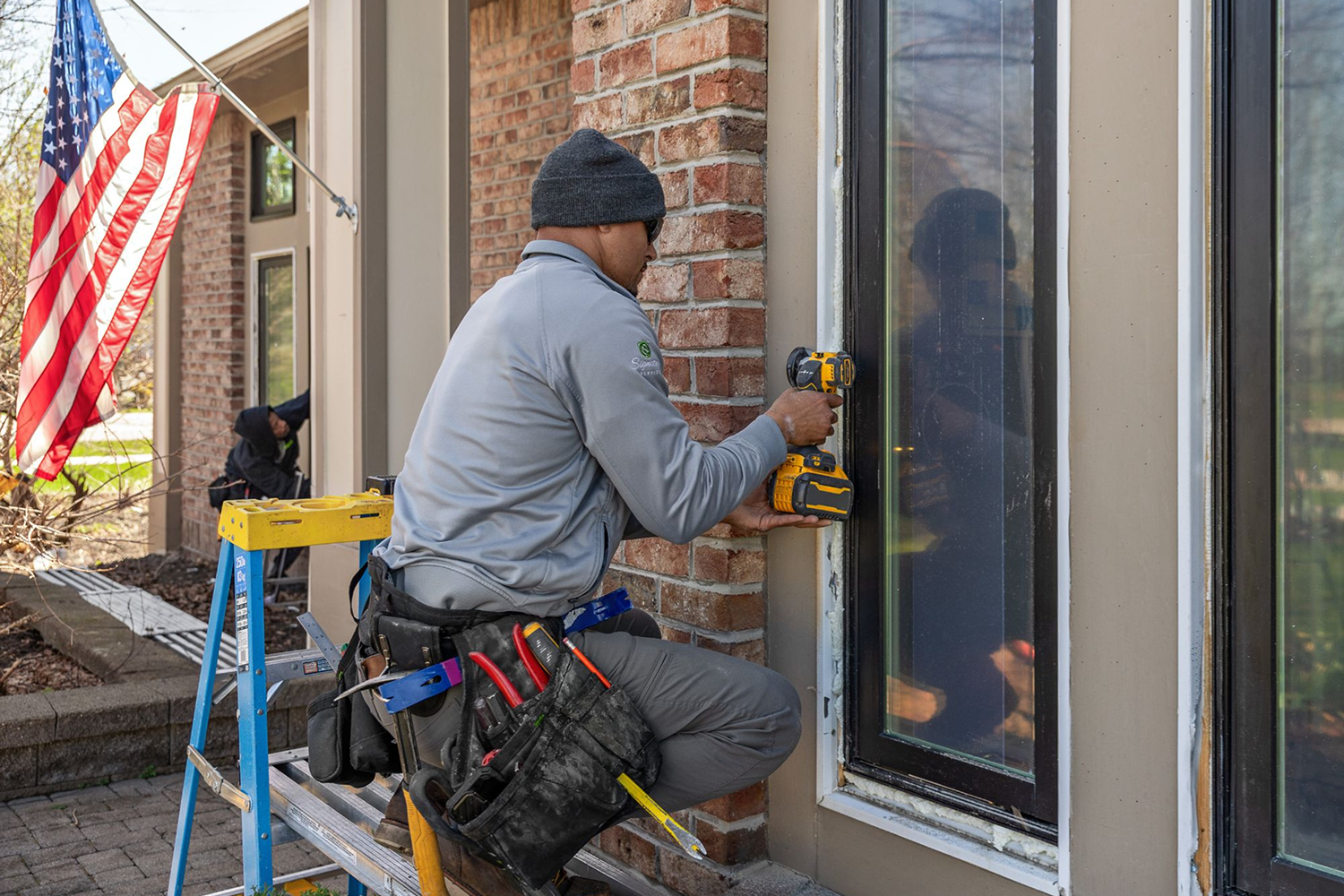 Renewal by Andersen installation professional installing a window.