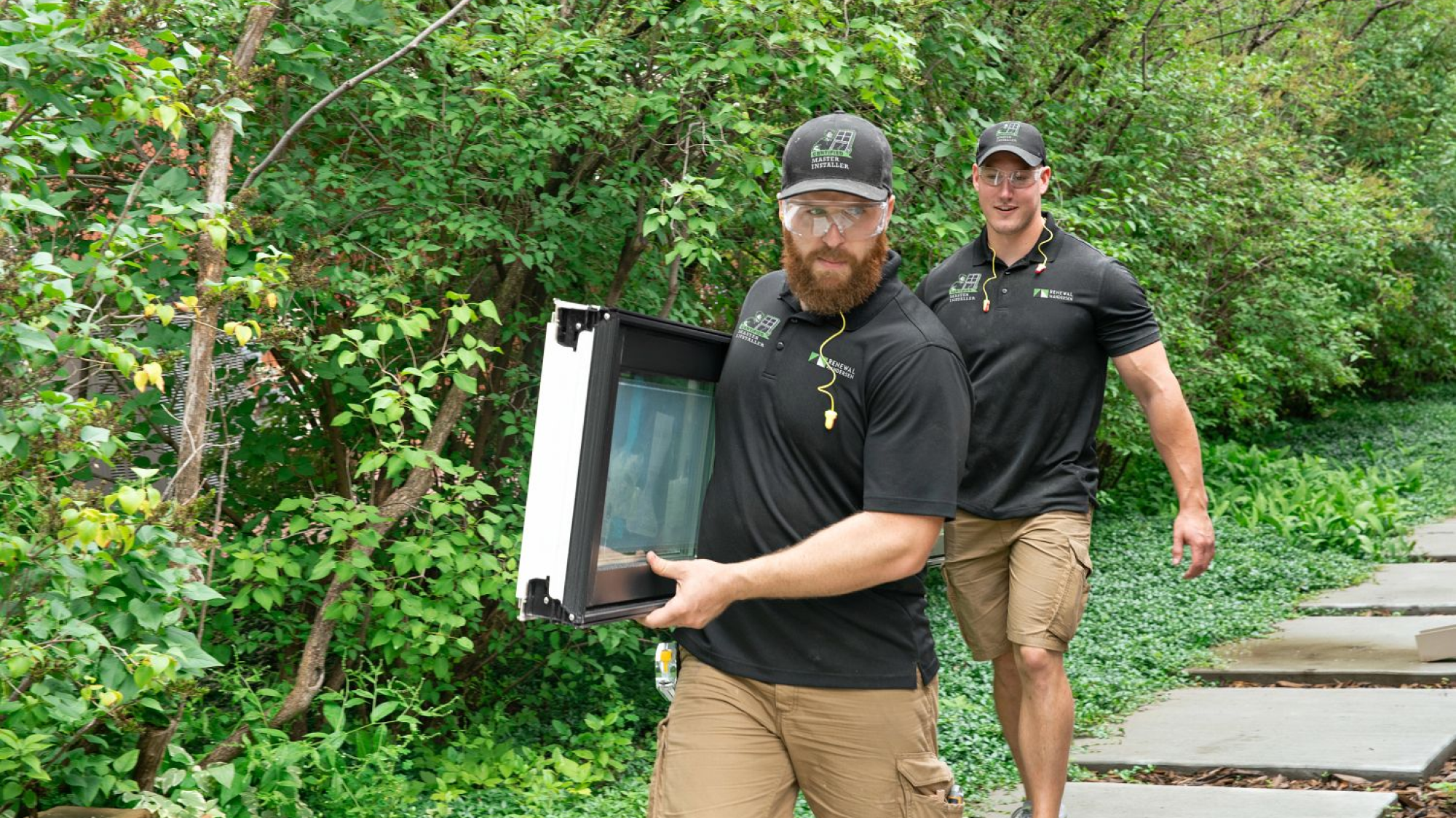 Two Installers carrying a window for installers