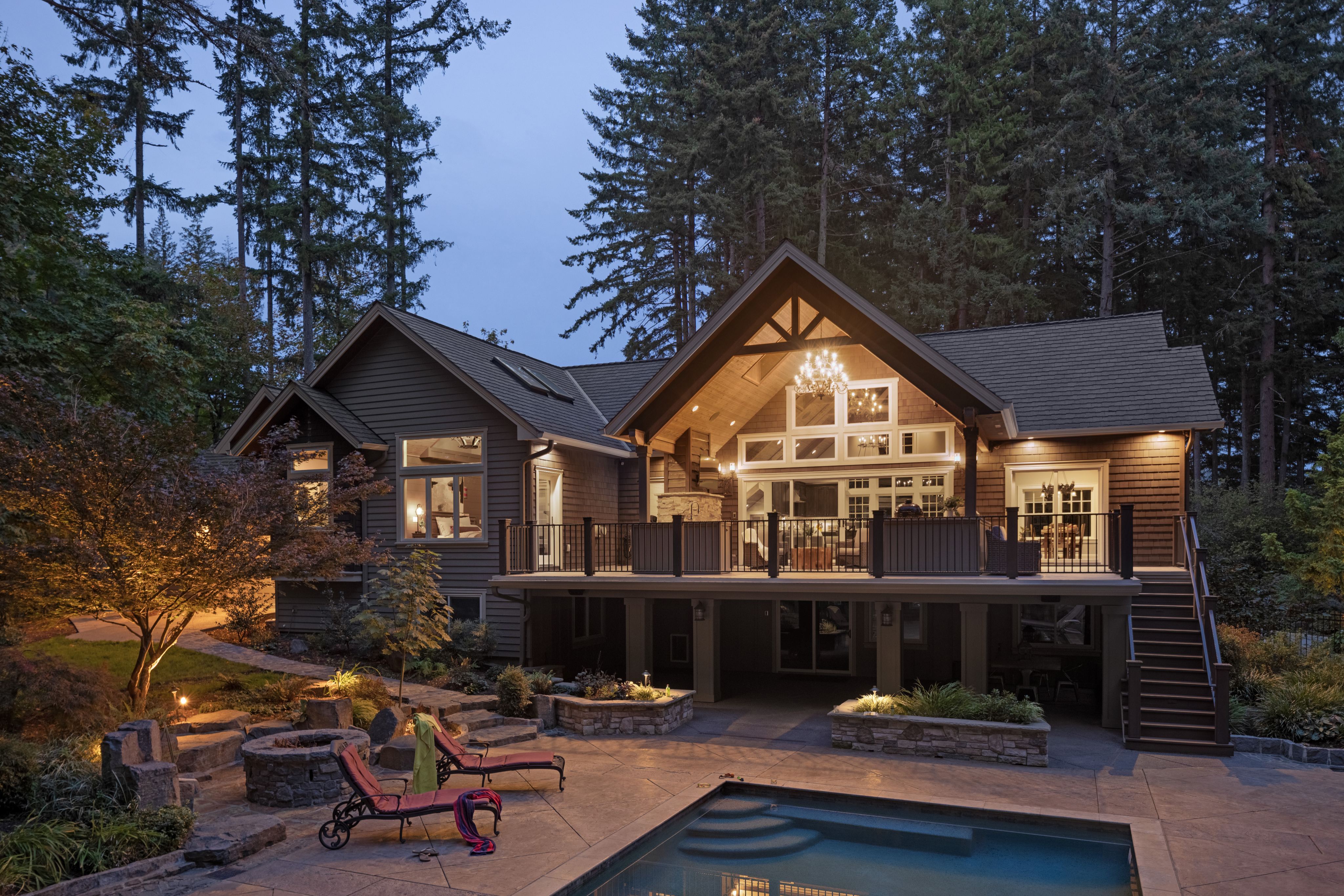 A house at sunset with new Renewal by Andersen windows, beautifully lit up.