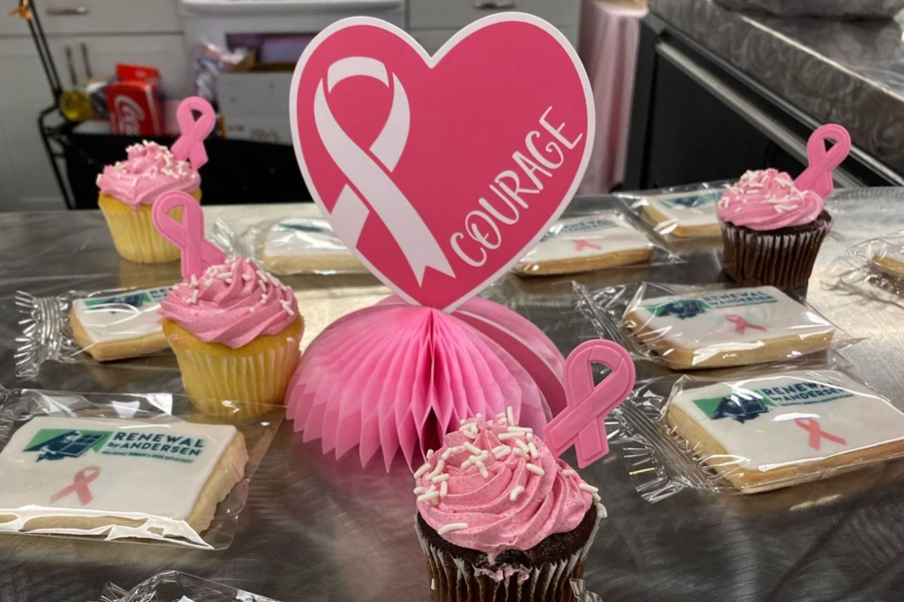 Pink cupcakes and cookies with Renewal by Andersen logo.