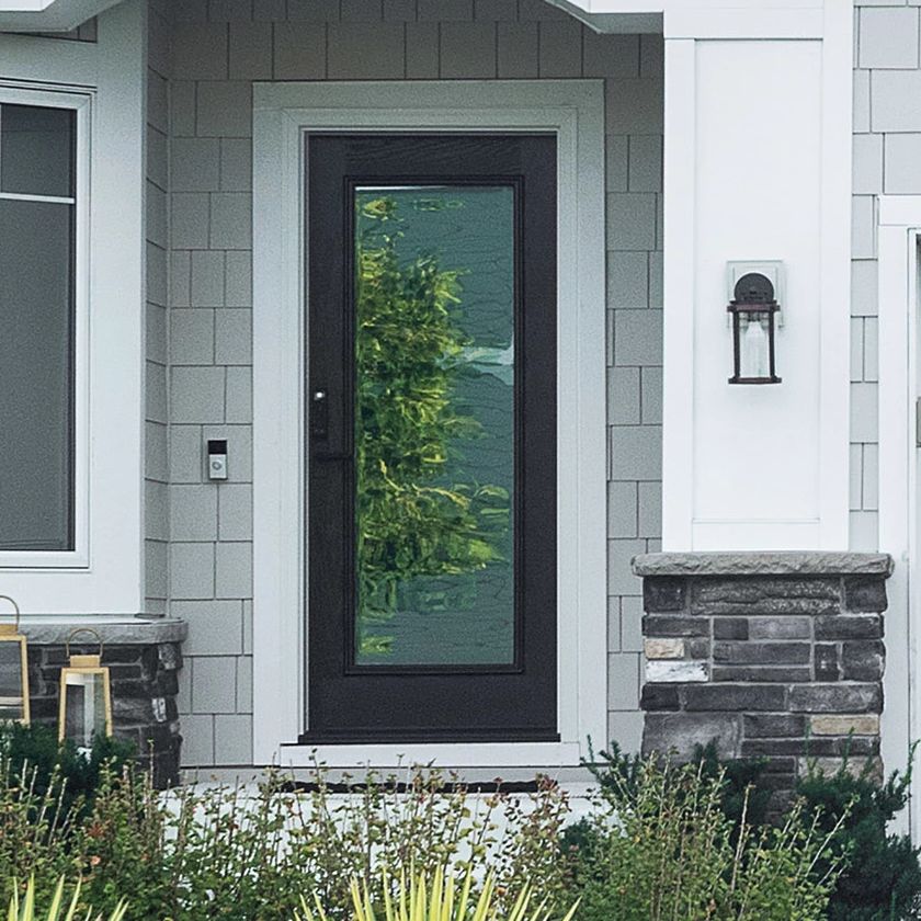 A single panel Ensemble entry door. The door is black and has full-light glass. It has white trim.