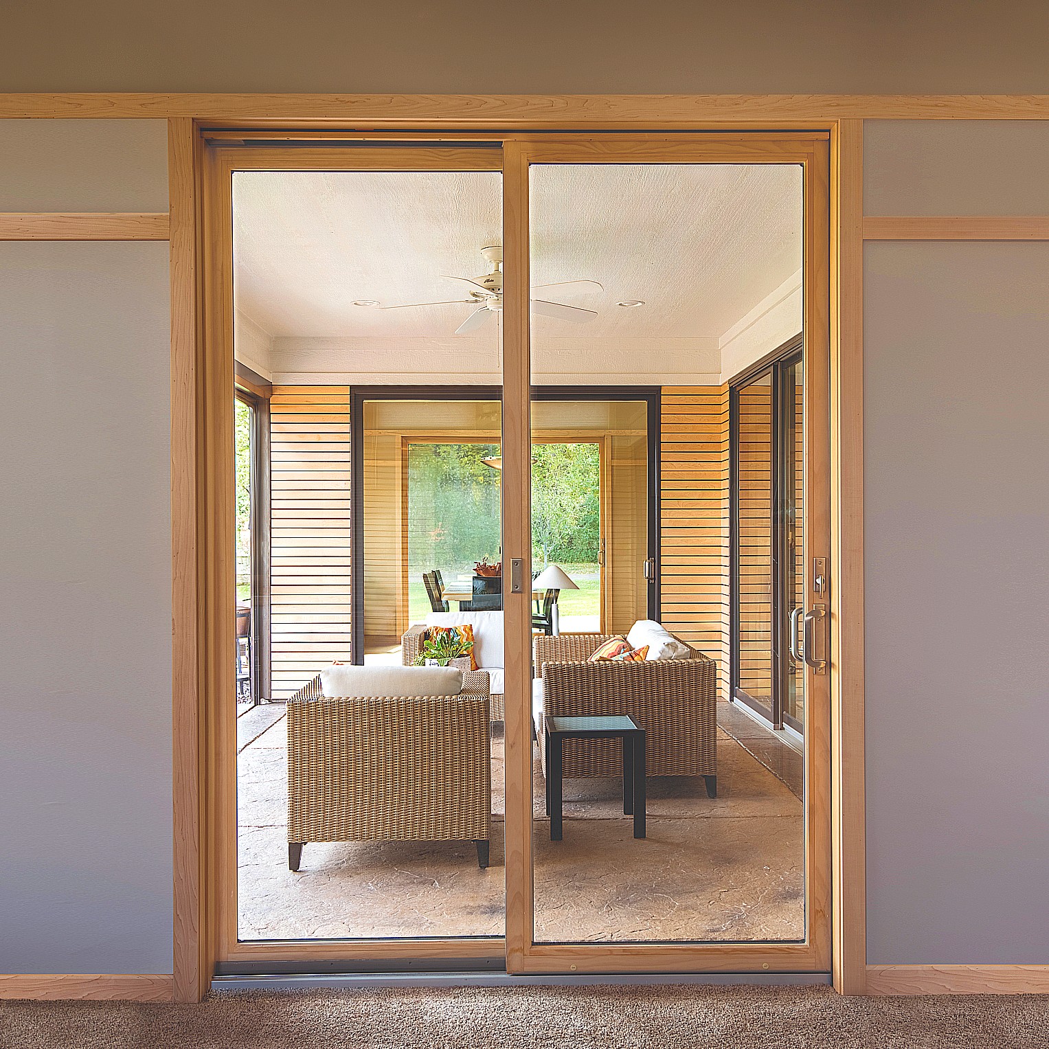 Narroline modern sliding patio doors with wood finish.