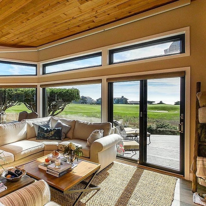 Modern contemporary sliding glass doors overlooking a patio and facing a golf course.