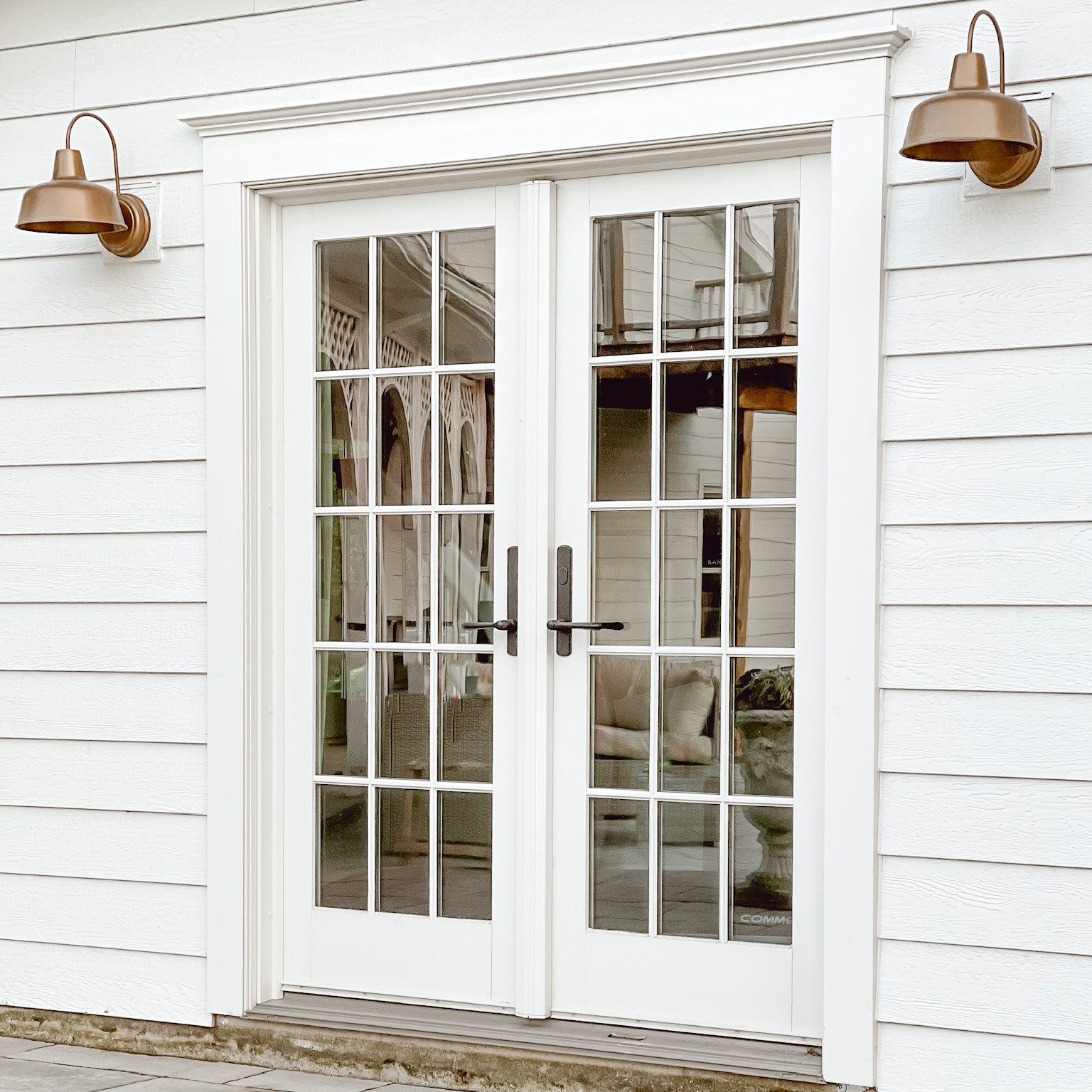 A set of A-Series hinged inswing doors with colonial grilles at Liz Marie Galvan's home.