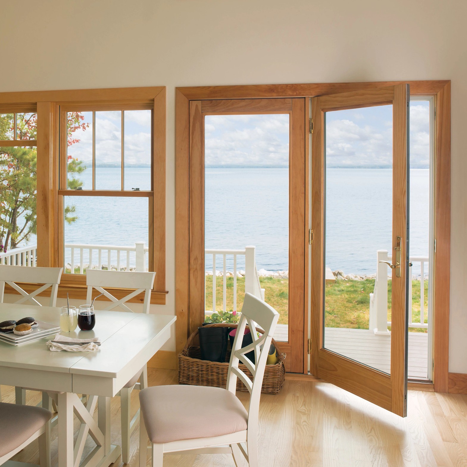 One fixed and one inswing a-series traditional doors in a coastal home. The doors have an oak stain.