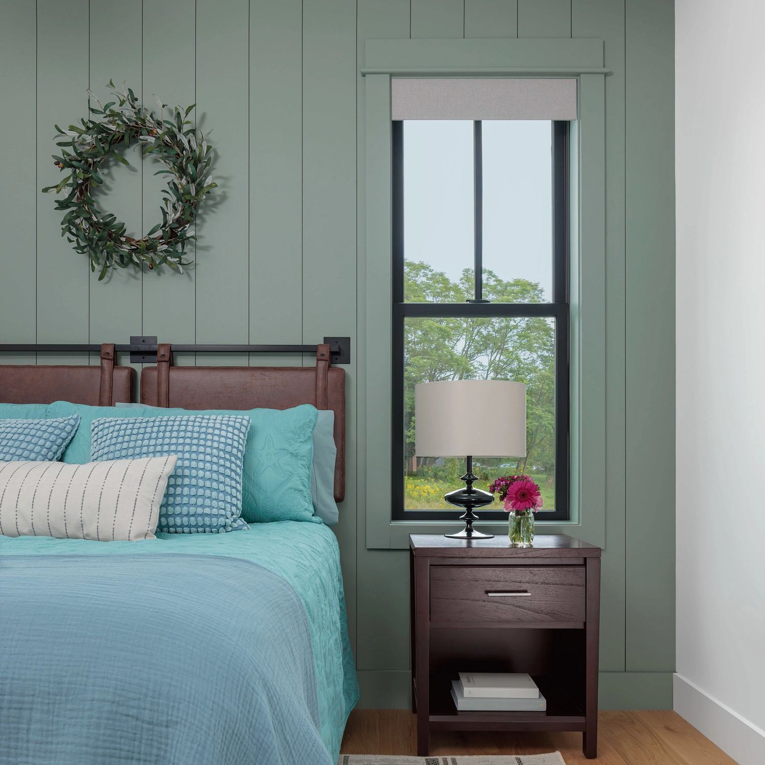 A double hung window with farmhouse grilles in a bedroom