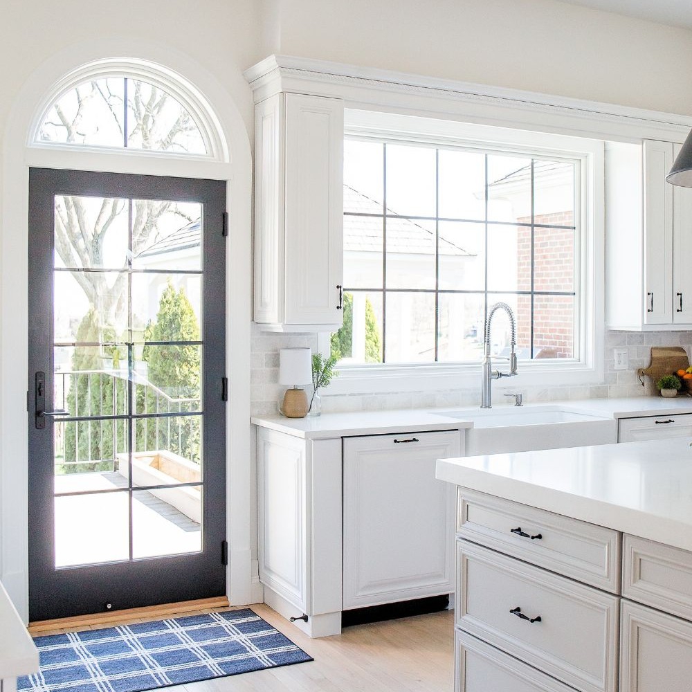 A chord window above an a-series traditional patio door in the Arched Manor house.