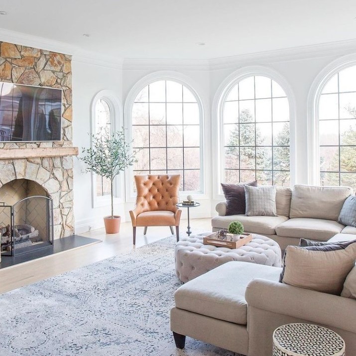 A trio of springline windows with black grilles in a living room.
