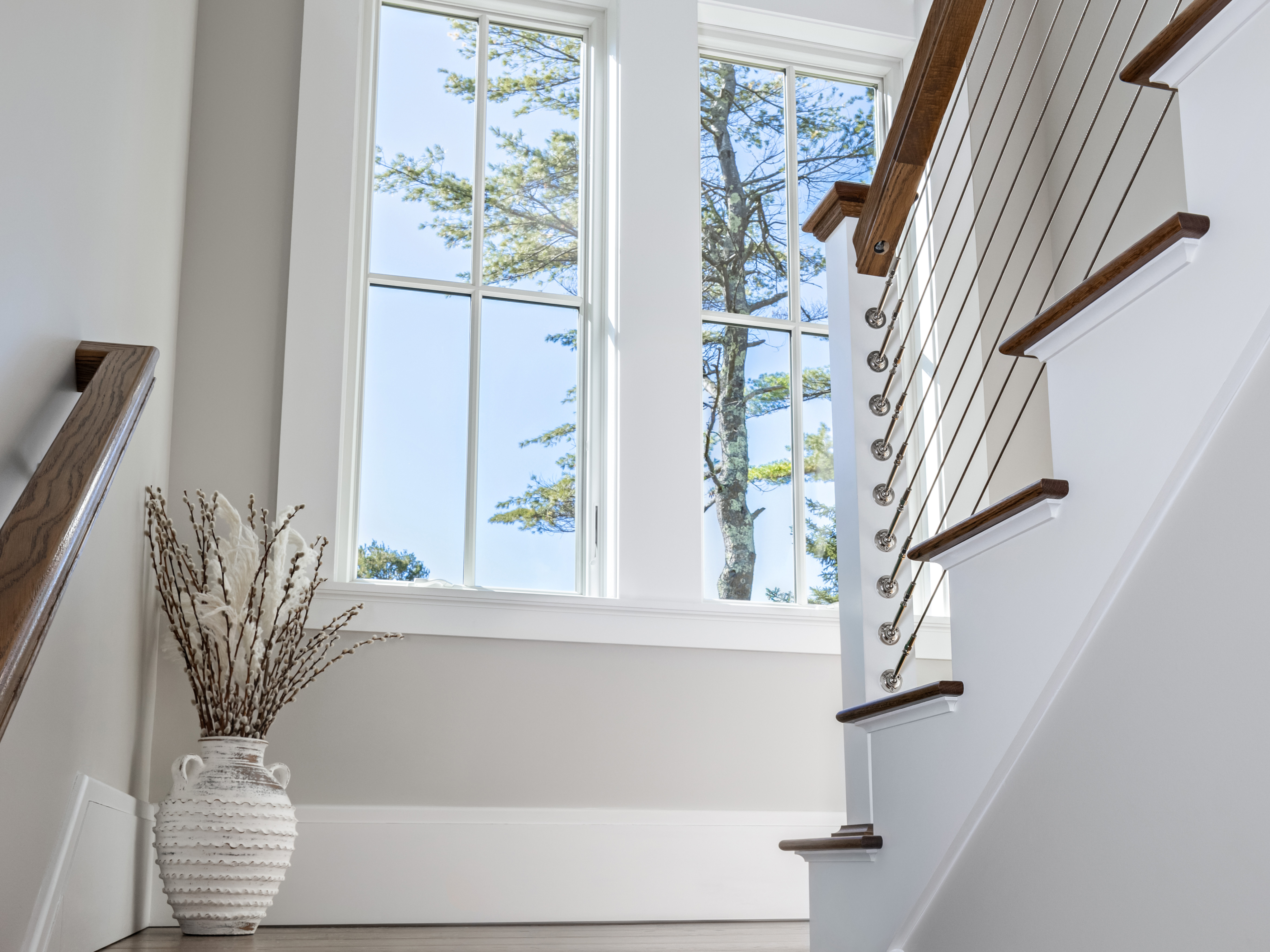 Going up the stairs with a view of double hung windows