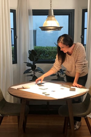 Laurie march works at her table in her alcove. She has lovely new black windows.