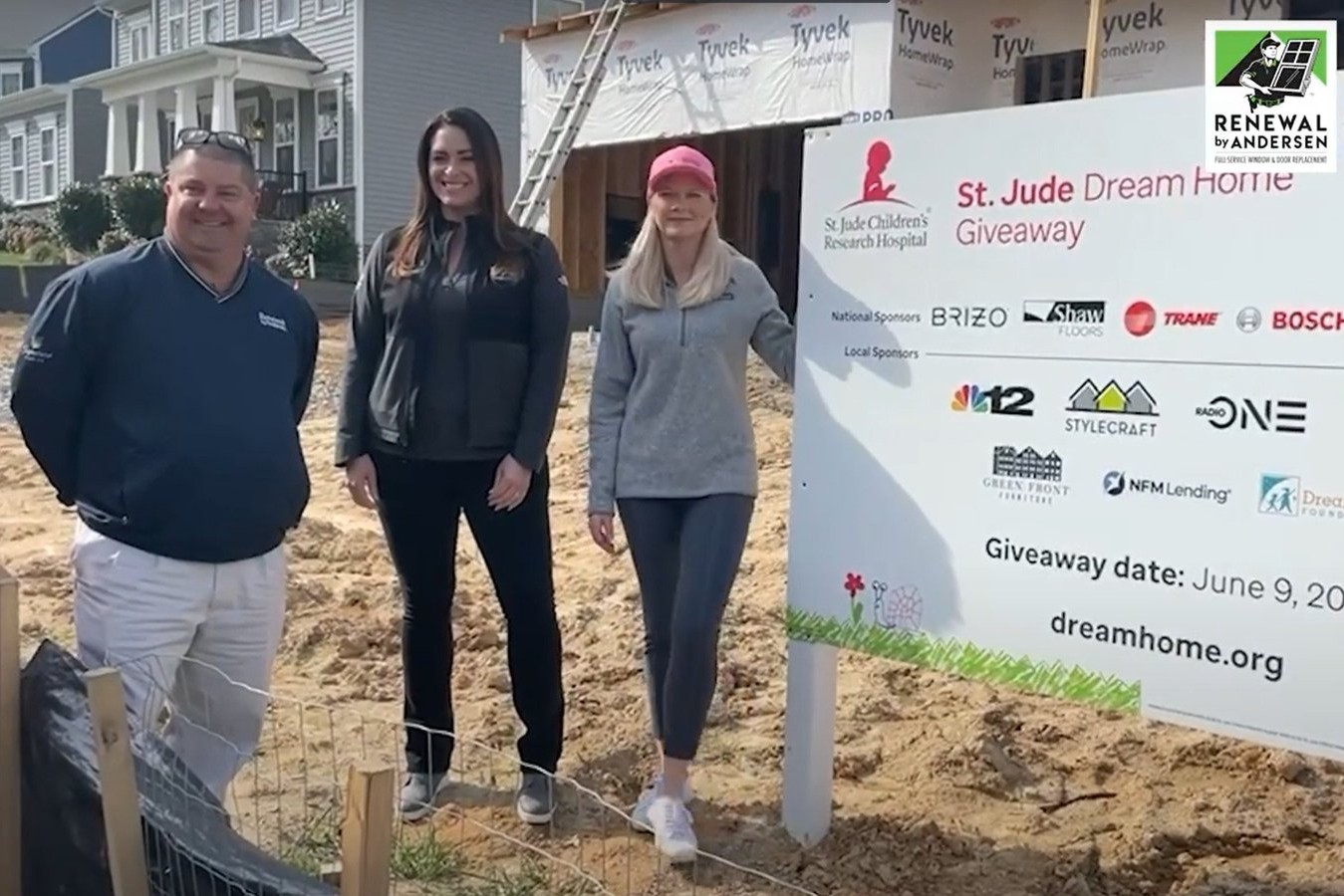 Three Renewal by Andersen employees standing in front of St. Jude Dream Home