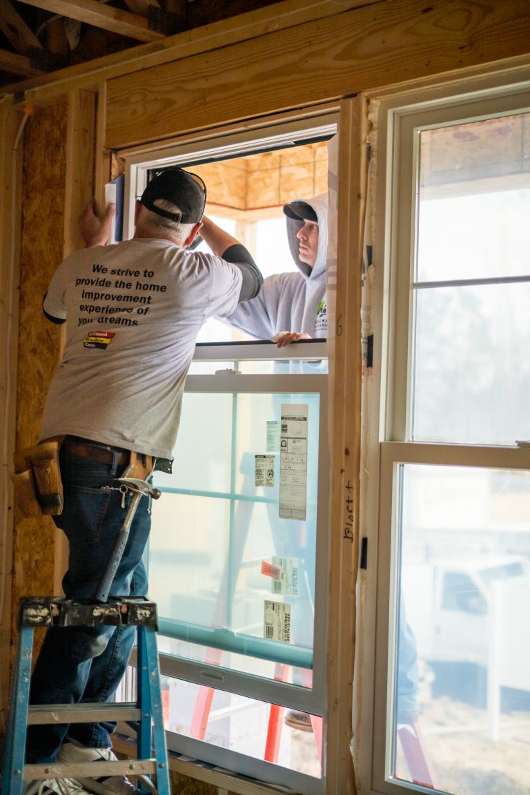 Renewal by Andersen installers installing a window in St. Jude Dream Home